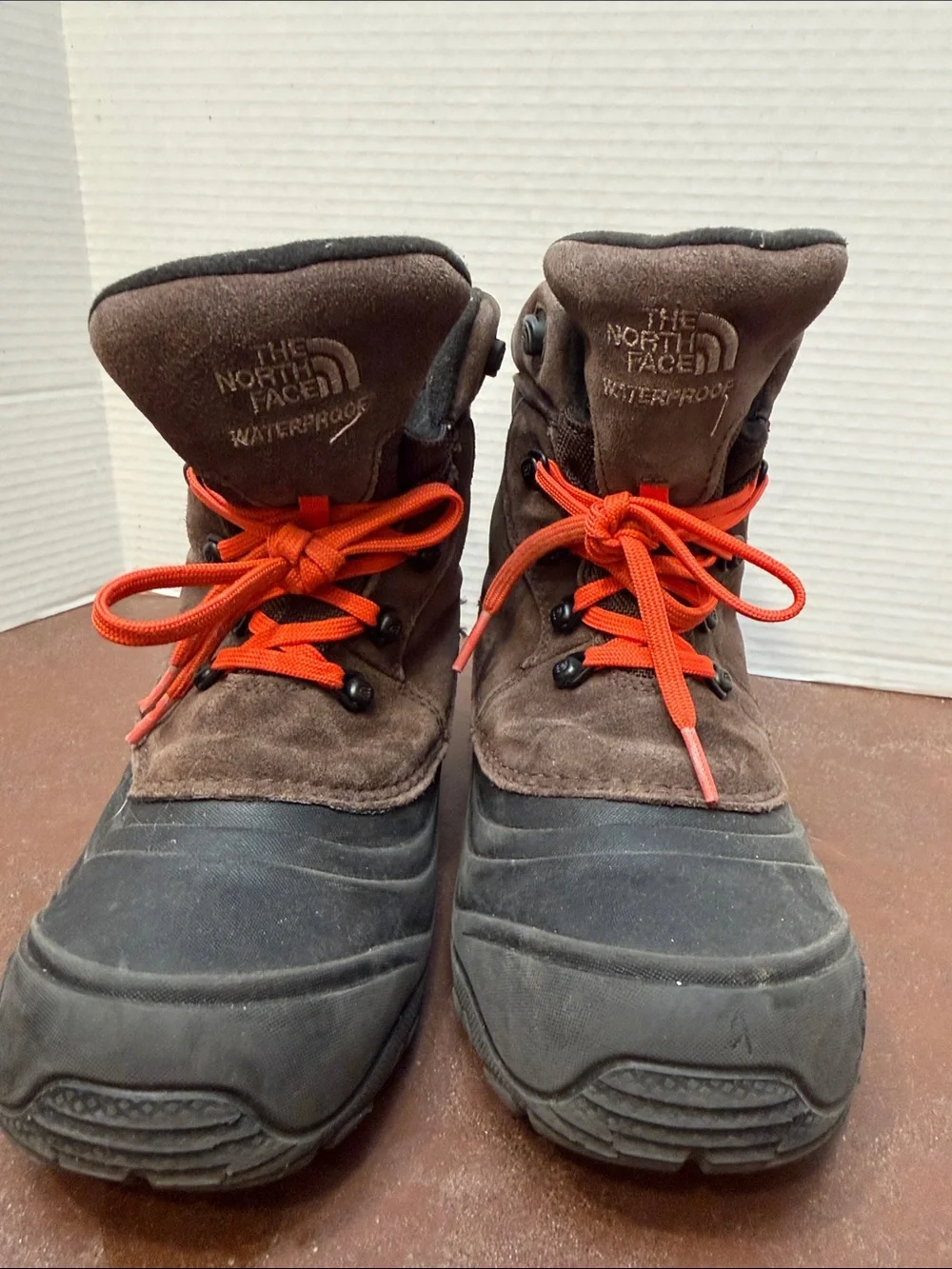 The North Face Kids Brown and Black Winter Boots with Orange Laces